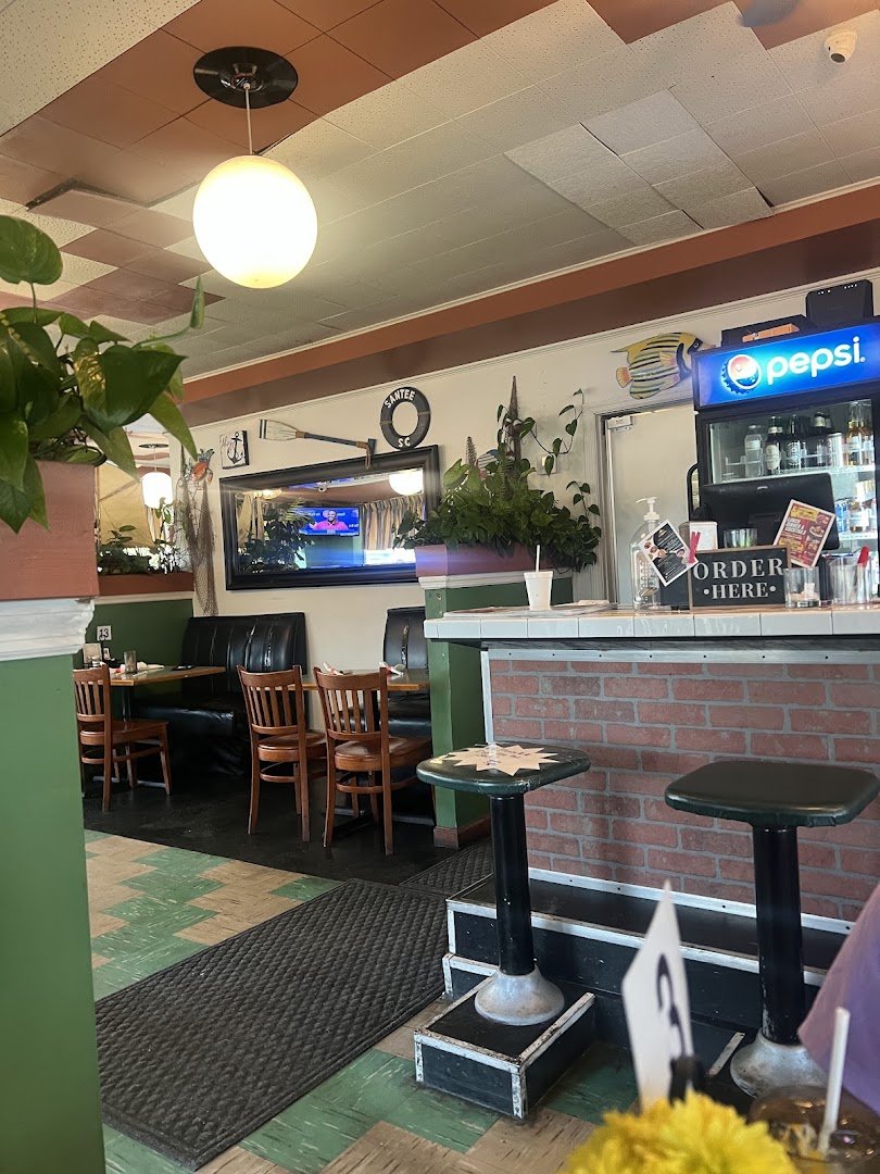 A menu page beside fresh seafood plates.