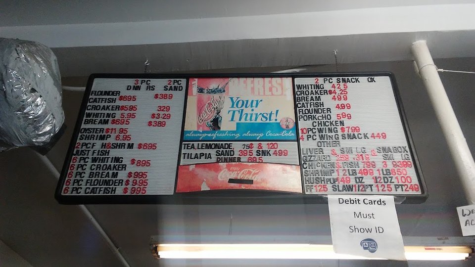 Printed menu with seafood specialties.